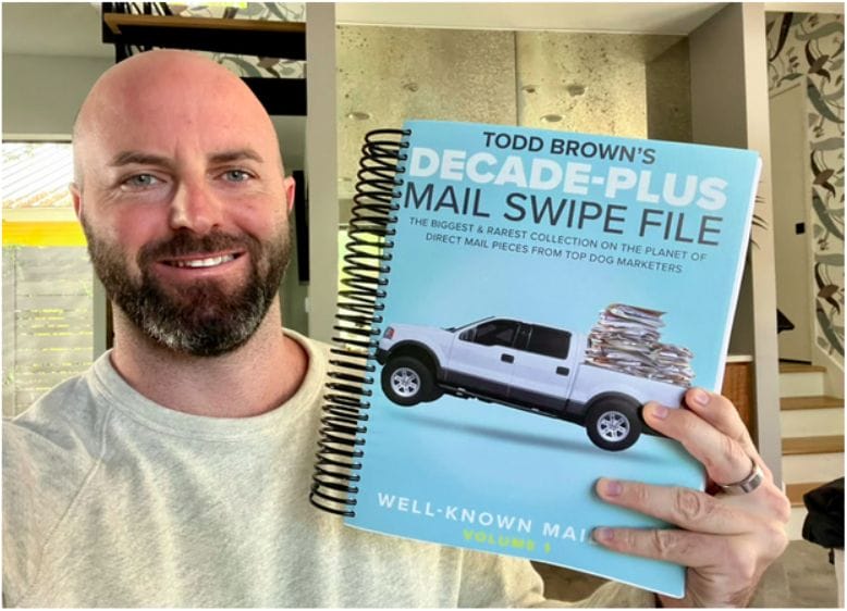 Justin holding Todd Brown Decade Plus Mail Swipes Book
